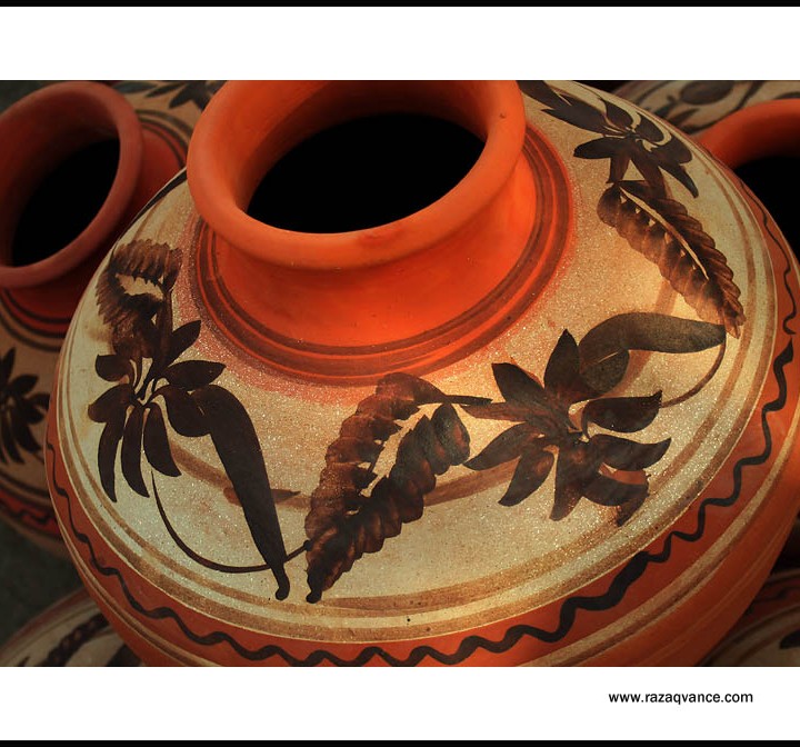 PAINTED PITCHER IN POTTERS STORE
