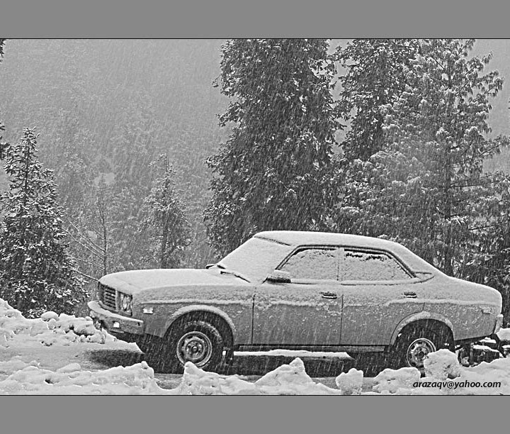 SNOW FALLING ON AN OLD CAR IN NATHIA GALI PAKISTAN