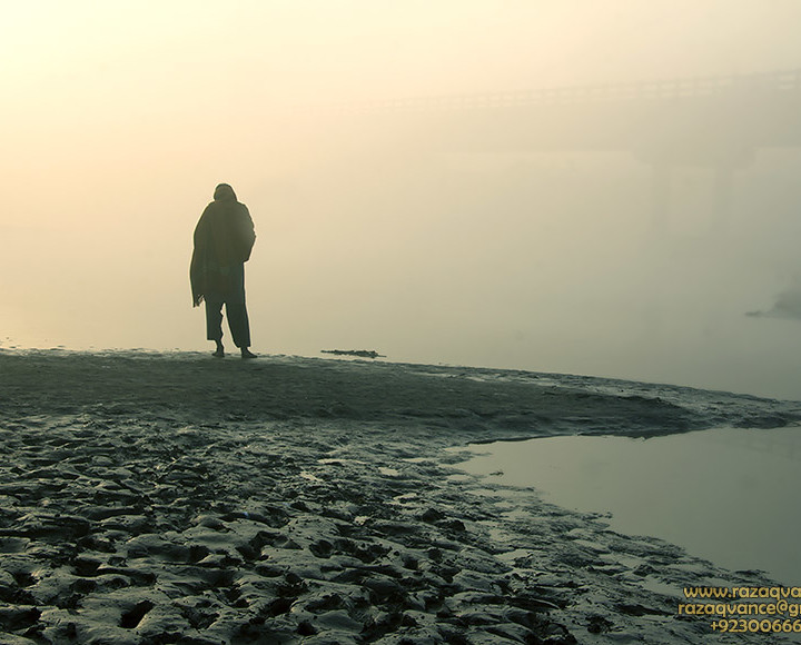 A BRIDGE IN THE MIST AND A LONE FIGURE ON THE RIVER RAVI