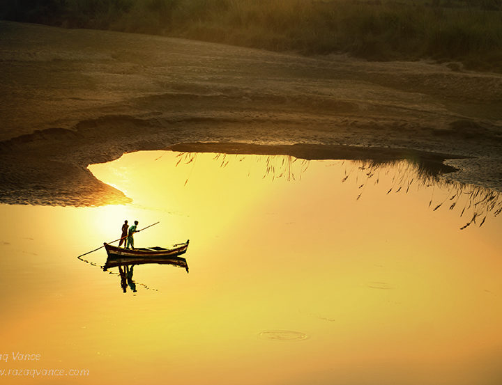 Fishermen Rowing and in Search of Fish in Dying River Ravi Pakistan